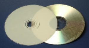 Abbildung 1: DVDs bestehen aus zwei je 0,6 Millimeter dicken Scheiben, die aufeinander geklebt werden. Die empfindliche Reflektionsschicht liegt in der Mitte des Mediums und ist so gut geschützt